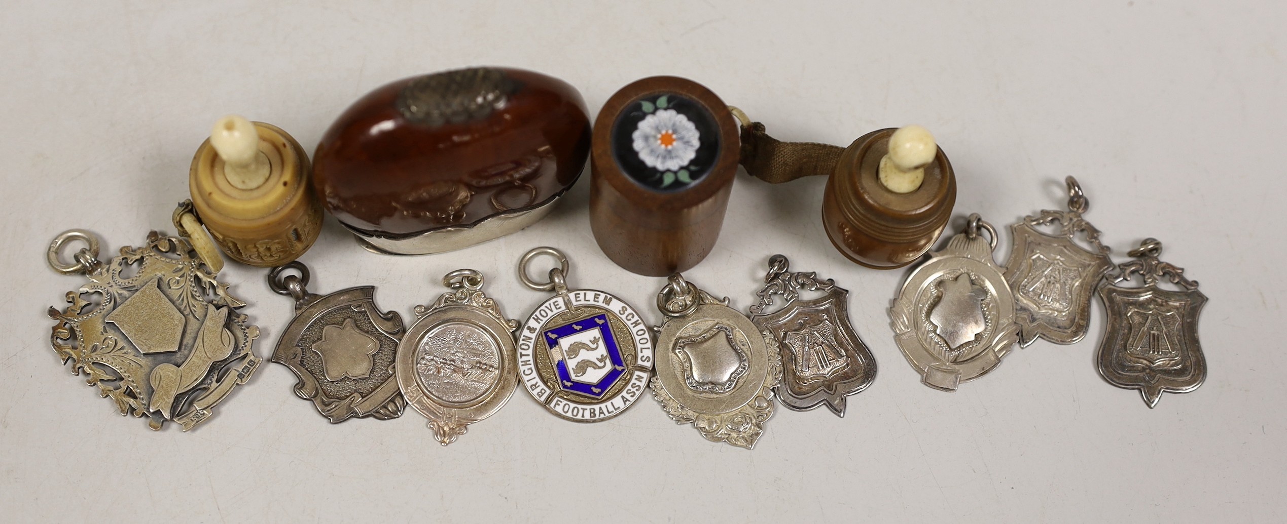 A ‘stag. silver’ mounted nut vesta case, two tape measures, a small box and sundry medallions